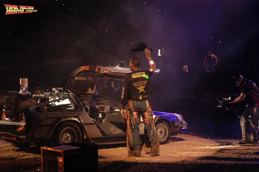 Valdiron de Oliveira tips waves his cowboy hat after exiting the DeLorean Time Machine rental car at the PBR Championships in Las Vegas, Nevada.