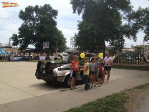 Generations of people young and old flock to the DeLorean Time Machine rental car for pictures and moments with a piece of replicated cinematic history